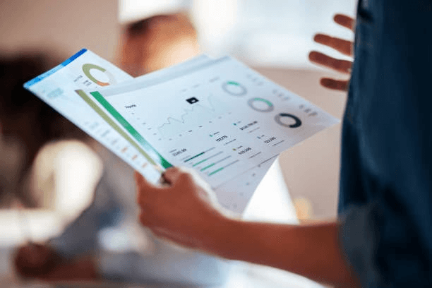 A manager reviewing printed performance reports